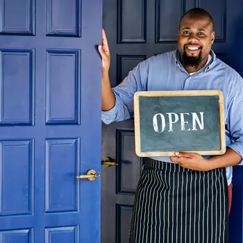 business owner holding Open sign